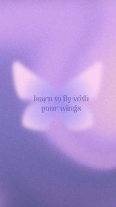 a blurry photo with the words learn to fly with your wings