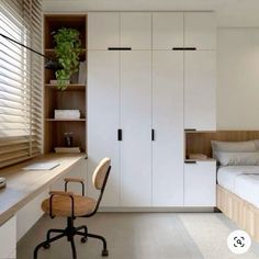 a bedroom with a bed, desk and closets in the wall next to it