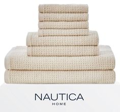 towels stacked on top of each other with the words nautica home written below them