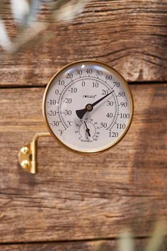 a close up of a thermometer on a wooden surface