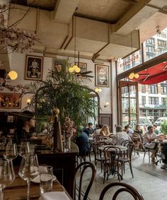 people are sitting at tables in a restaurant