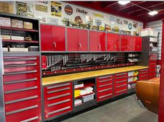 a garage with lots of red cabinets and drawers