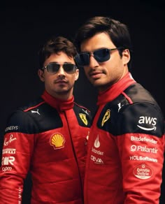 two men in red racing suits and sunglasses