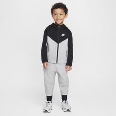 Made of bonded jersey knit fabric, this 2-piece set is inspired by the classic warmup suit. The hoodie has a full-zip closure that makes layering easy, and the matching tapered pants have ribbed cuffs and an elasticized waistband for a comfy fit the smallest athletes can play freely in. Tech Fleece Outfit, Fleece Outfit, Nike Sportswear Tech Fleece, Nike Looks, Kids Sportswear, Tapered Joggers, Hoodie Set, Nike Tech Fleece, Tapered Trousers