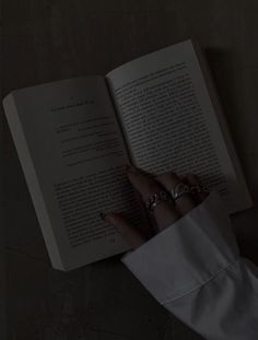 a person reading a book in the dark