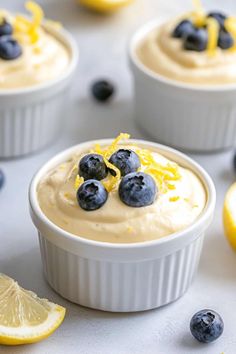 blueberries and lemons are garnished with icing in small white dishes