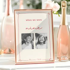 a bottle of wine sitting next to a photo frame with two women's faces on it