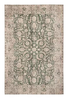 an antique rug with green and beige colors