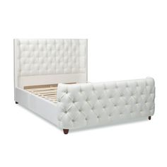 a white bed with tufted headboard and foot board