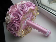 a bridal bouquet sitting on top of a window sill