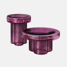 two purple glass tables sitting next to each other