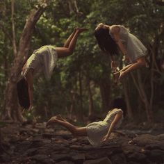 two people jumping in the air with trees behind them and text that reads trance against the gravity