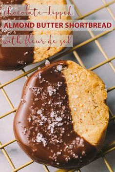 two chocolate dipped almond butter shortbreads on a cooling rack with text overlay