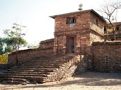 an old brick building with stone steps leading up to it