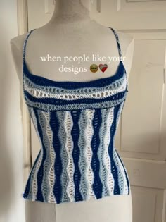 a white mannequin with blue and white crochet on it's torso