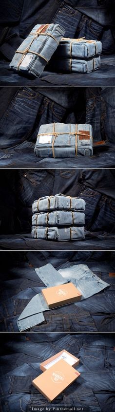 several stacks of blue jeans stacked on top of each other with papers sticking out of them