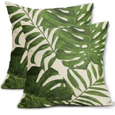 two pillows with green leaves on them