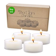 four tealight candles sitting in front of a box