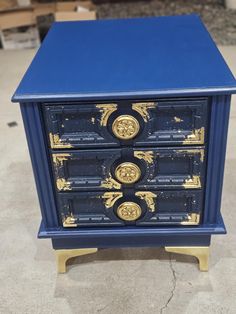 a blue and gold painted chest of drawers