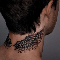 a man's neck with an angel wing tattoo on the back of his neck