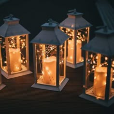 lighted lanterns are sitting on a wooden table