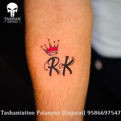 a man with a crown tattoo on his arm and the word r k written in black ink