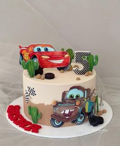 a birthday cake decorated with cars and numbers