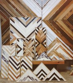 a group of wooden pieces sitting on top of a table in front of a wall