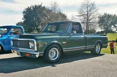 an older pickup truck parked next to a younger one