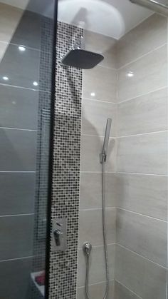 the shower head is mounted to the side of the wall in this modern style bathroom