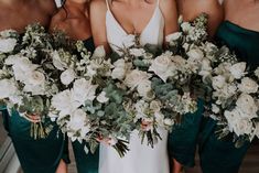 the bridesmaids are holding their bouquets with white and green flowers on them