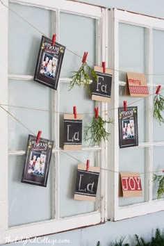 there are pictures hanging on the wall with clothes pins attached to them and some plants