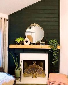 a living room with a fireplace, mirror and potted plants on the mantel