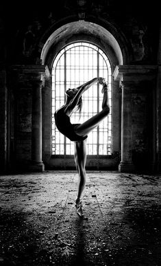 black and white photograph of a ballerina in an old building