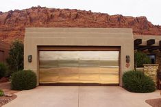 a large garage door in front of a mountain