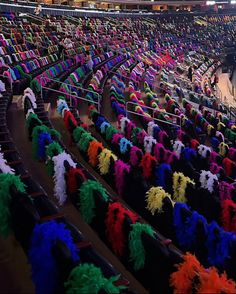 rows of chairs with colorful decorations on them at a basketball game in an indoor arena