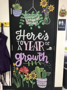 there's a year of growth written on a door with flowers and cacti