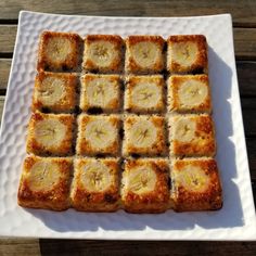 a square white plate topped with sliced bananas