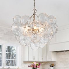 a chandelier hanging from the ceiling in a kitchen