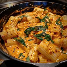 pasta with spinach and cheese in a skillet