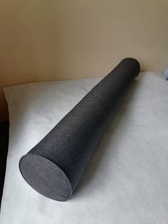 a roll of fabric sitting on top of a bed