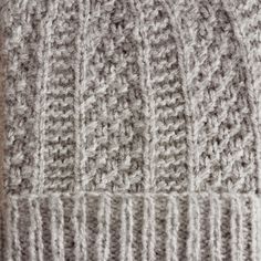 a close up view of a knitted blanket with two rows of stitches on it