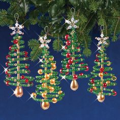 three christmas tree ornaments hanging from a fir tree with red, green and gold beads