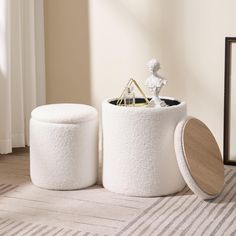 two white stools sitting on top of a rug