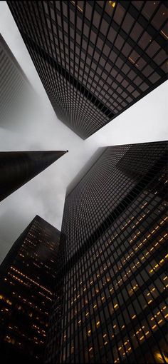 looking up at the tops of skyscrapers in new york city