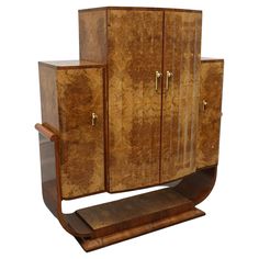 an art deco cabinet with two doors and drawers