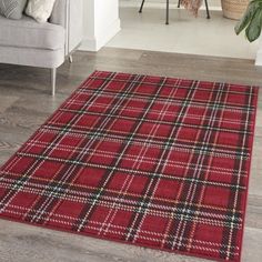 a red and black plaid rug in a living room