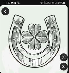 a drawing of a horseshoe with four leaf clover