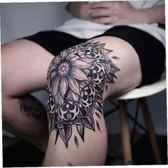 a woman's thigh with tattoos on her legs and the leg is covered in flowers