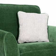 a green couch with a white pillow on it's back and the seat up